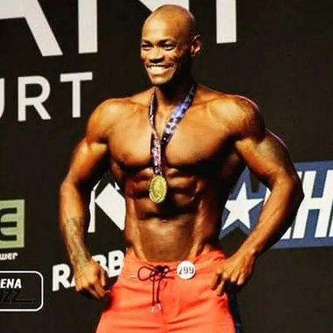 Antony Bessala wearing a medal on stage at Arnold Sports Festival Australia
