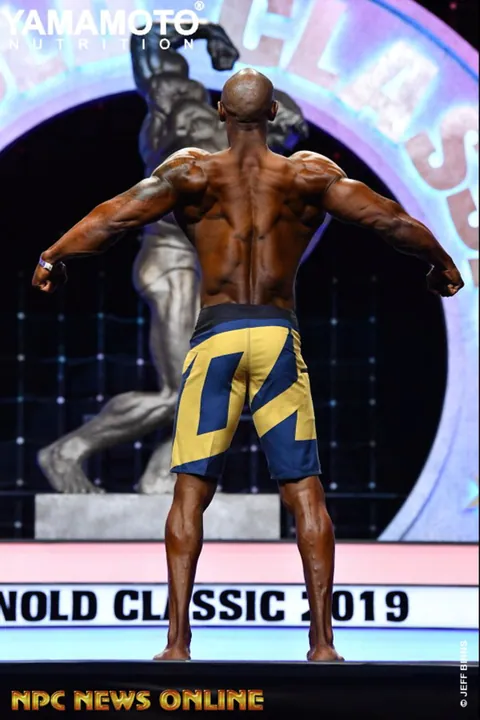 Antony Bessala seen from behind on the Arnold Classic 2019 stage