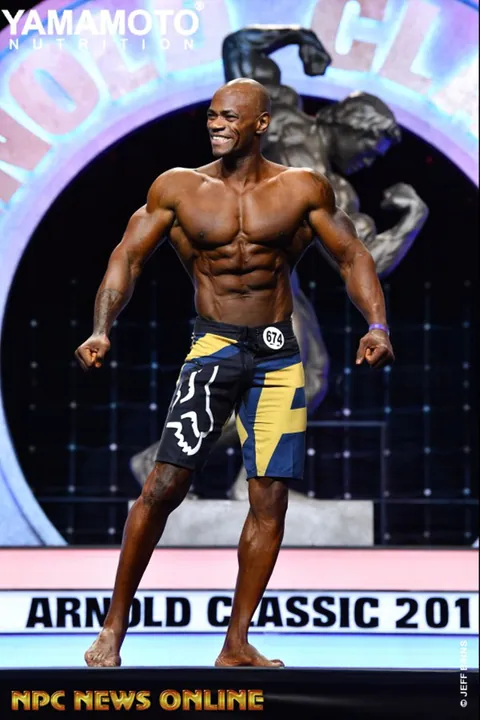 Antony Bessala smiling in a relaxed pose on the Arnold Classic 2019 stage