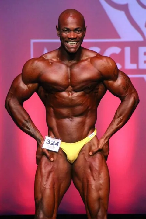 Antony Bessala on the Musclemania Pro stage: front lat spread, number 324